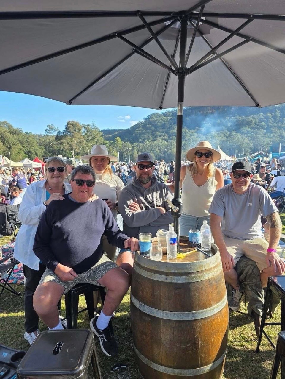 Friends gathered around a barrel table at Glenworth Valley