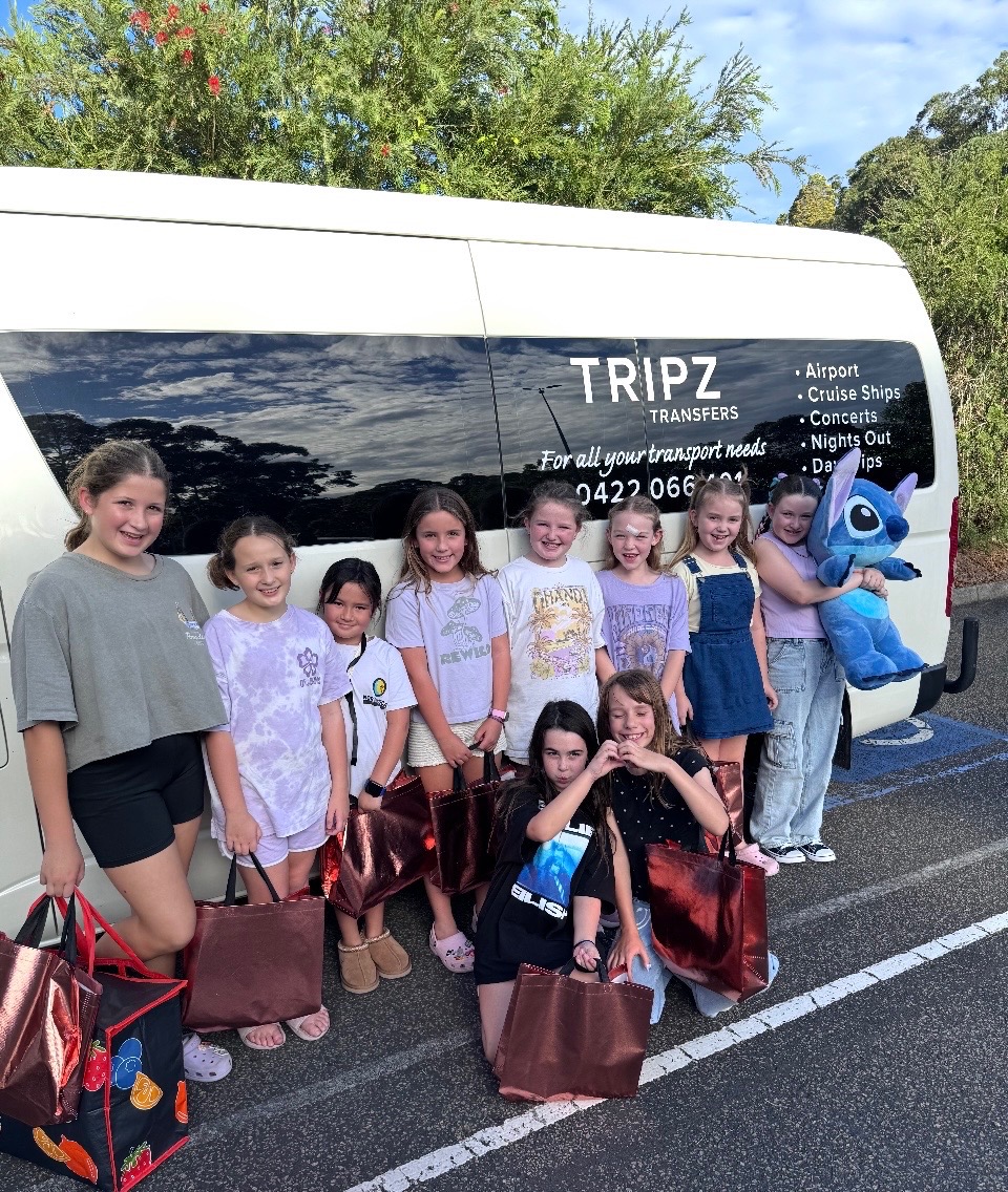 Children posing together beside the TRIPZ van for a birthday party