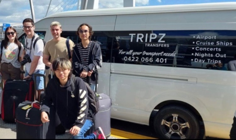 Family with luggage beside the TRIPZ van for an airport transfer
