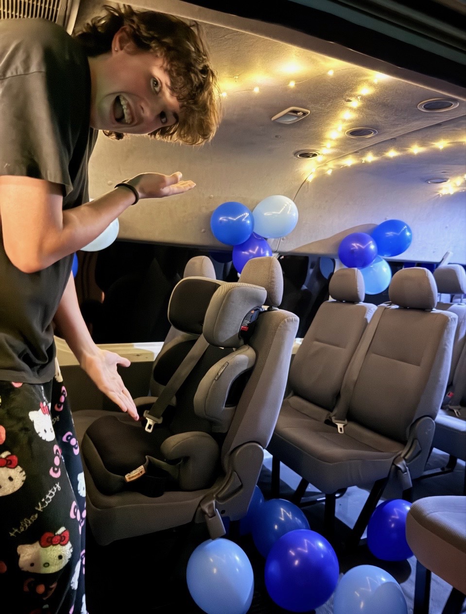 Blue birthday balloons and party decorations inside the TRIPZ van